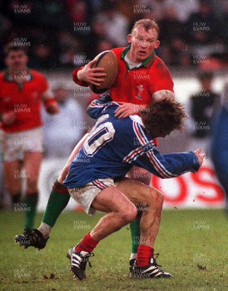 210195 - Wales v France - Five Nations - Neil Jenkins of Wales is tackled by Christophe Deylaud