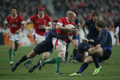 27.02.09 France v Wales... Wales' Martyn Williams is tackled by France's Morgan Parra. 