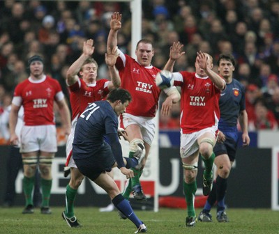 27.02.09 France v Wales... Wales' Dwayne Peel, Gethin Jenkins and Martyn Williams try to stop a kick by France's Francois Trinh-Duc. 