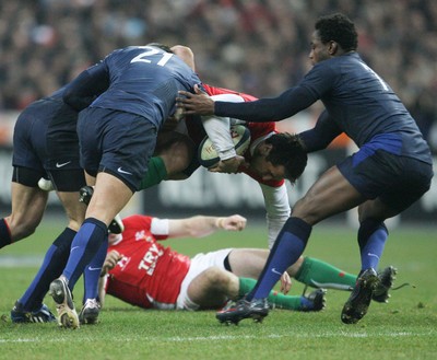 27.02.09 France v Wales... Wales' Gavin Henson is tackled by a trio of French players. 