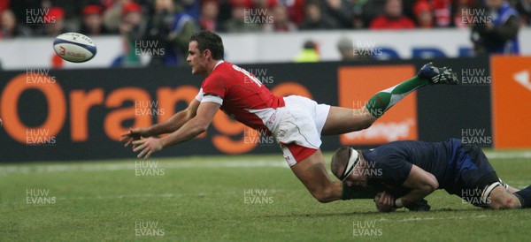 27.02.09 France v Wales... Wales' Lee Byrne is tackled by France's Imanol Harinordoquy. 