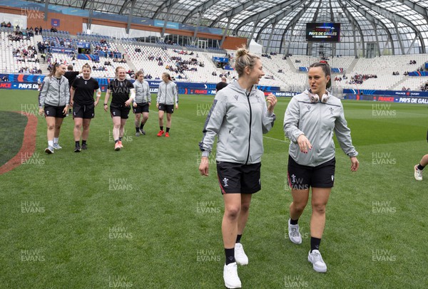 230423 - France v Wales, TicTok Women’s 6 Nations - Elinor Snowsill of Wales and Ffion Lewis of Wales walk the pitch ahead of warm up