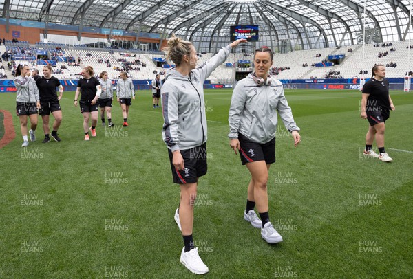 230423 - France v Wales, TicTok Women’s 6 Nations - Elinor Snowsill of Wales and Ffion Lewis of Wales walk the pitch ahead of warm up