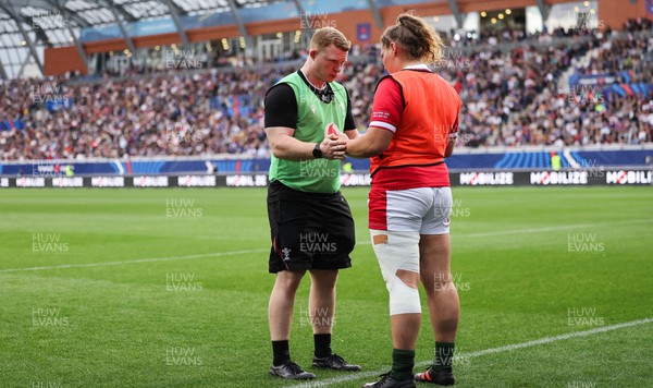 230423 - France v Wales, TicTok Women’s 6 Nations - Strength and conditioning coach Jamie Cox works with Gwenllian Pyrs of Wales during the match