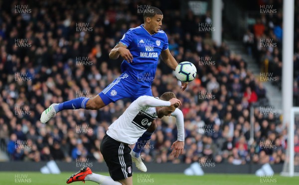 270419 - Fulham v Cardiff City, Premier League - Lee Peltier of Cardiff City gets above Calum Chambers of Fulham to head the ball