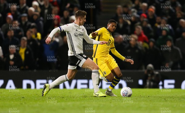 260220 - Fulham v Swansea City, Sky Bet Championship - Tom Cairney of Fulham is tackled by Rhian Brewster of Swansea City