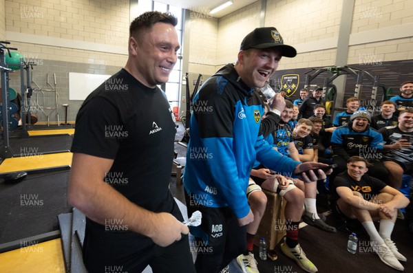 280223 - Gerwyn Price visits the Dragons RFC - Former PDC World Champion and current world number 4 Gerwyn Price plays a game of darts against Dragons Players Darts Champion Joe Westwood as team mates look on during a visit to the team’s training session