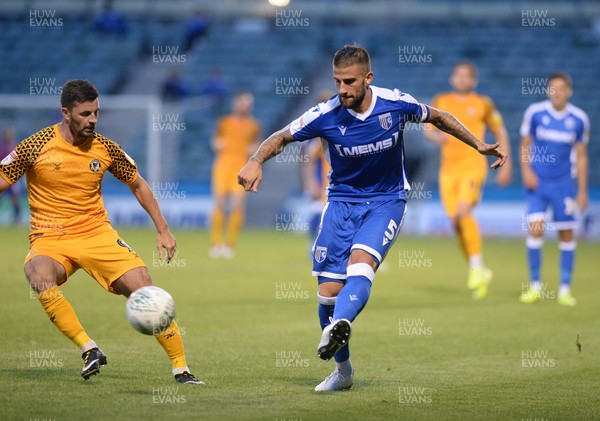 130819 - Gillingham v Newport County - Carabao Cup 1st Round -  Gillingham's Max Ehmer clears watched by Newport's Padraig Amond
