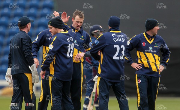 240314 - Glamorgan CCC v Cardiff MCCU - Preseason Friendly - Huw Waters of Glamorgan celebrates with Chris Cooke after getting his first wicket