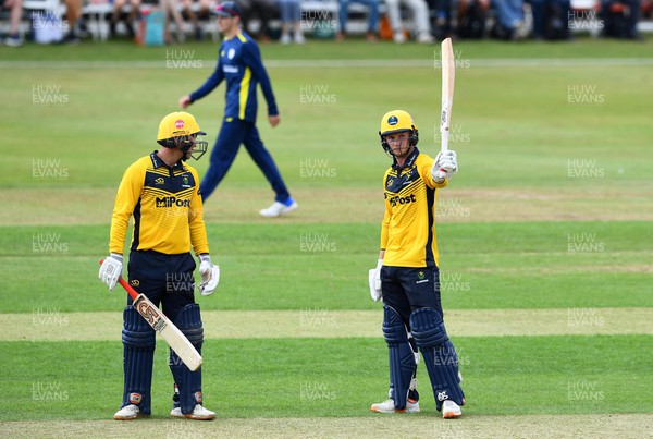 190822 - Glamorgan v Hampshire - Royal London Cup - Tom Bevan (right) of Glamorgan celebrates 50 with Colin Ingram