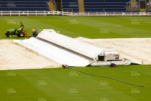 010423 - Glamorgan v Cardiff UCCE - Preseason Friendly - Covers on the pitch during a rain delay ahead of the match