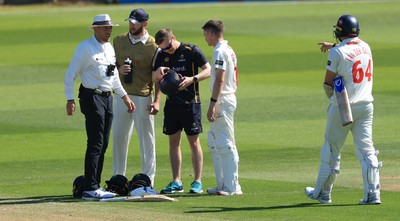 030525 - Glamorgan v Derbyshire, Rothesay County Championship Division 2, Day 2 - Andy Gorvin helmet is inspected after the Glamorgan player’s face guard was struck by the ball