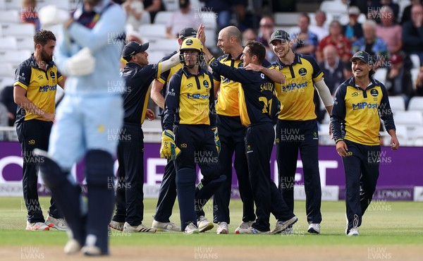 190821 - Glamorgan v Durham - Royal London One Day Final - James Weighell of Glamorgan celebrates with Andrew Salter and team mates as he catches out Graham Clark