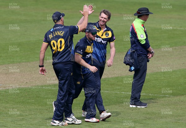 170419 - Glamorgan Cricket v Essex - Royal London One-Day Cup - Michael Hogan of Glamorgan celebrates the wicket of Ryan ten Doeschate with Marchant De Lange who is caught by Kiran Carlson