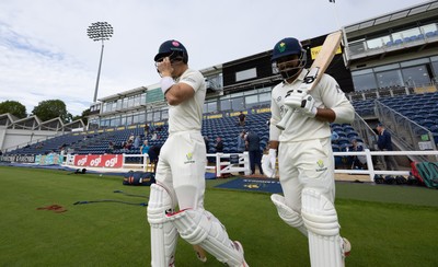 240926 Glamorgan v Essex, Rothesay County Championship Division 1 - Asa Tribe of Glamorgan and Zain ul Hassan of Glamorgan walk out at the start of the innings