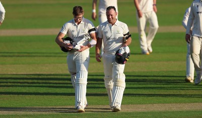 240926 Glamorgan v Essex, Rothesay County Championship Division 1 - Asa Tribe of Glamorgan, left, leaves the pitch at the end of the day’s play on 135 not out, along with Colin Ingram of Glamorgan