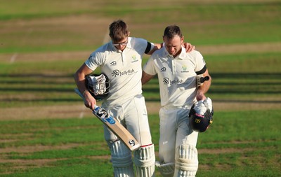 240926 Glamorgan v Essex, Rothesay County Championship Division 1 - Asa Tribe of Glamorgan, left, leaves the pitch at the end of the day’s play on 135 not out, along with Colin Ingram of Glamorgan