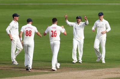 260926 - Glamorgan v Essex - Rothesay County Championship Division 1 - Ray Toole of Glamorgan celebrates taking the wicket of Zaman Akhter with Dan Douthwaite and Kiran Carlson