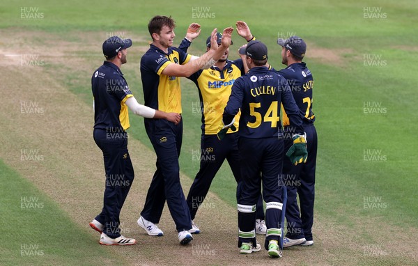 160821 - Glamorgan v Essex Eagles - Royal London One-Day Cup - Joe Cooke celebrates with Andrew Salter of Glamorgan and team mates after Josh Rymell is caught out by Salter