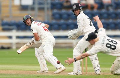 010725  Glamorgan v Gloucestershire, Rothesay County Championship Division 2 - Colin Ingram of Glamorgan plays a shot past Miles Hammond of Gloucestershire