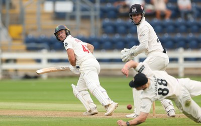 010725  Glamorgan v Gloucestershire, Rothesay County Championship Division 2 - Colin Ingram of Glamorgan plays a shot past Miles Hammond of Gloucestershire