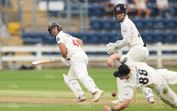010725  Glamorgan v Gloucestershire, Rothesay County Championship Division 2 - Colin Ingram of Glamorgan plays a shot past Miles Hammond of Gloucestershire