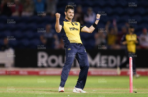 010819 - Glamorgan v Gloucestershire, Vitality Blast 2019 - Lukas Carey of Glamorgan celebrates as Benny Howell of Gloucestershire is caught off his bowling by Billy Root of Glamorgan