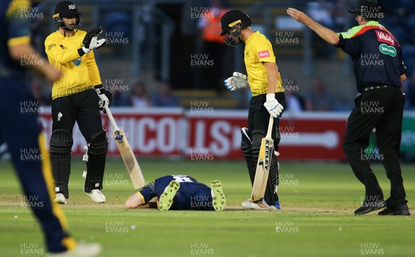 030818 - Glamorgan v Gloucestershire, Vitality Blast - Gloucestershire batsmen Ryan Higgins and Jack Taylor call for assistance after Graham Wagg of Glamorgan is struck by the ball while bowling