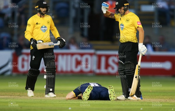 030818 - Glamorgan v Gloucestershire, Vitality Blast - Gloucestershire batsmen Ryan Higgins and Jack Taylor call for assistance after Graham Wagg of Glamorgan is struck by the ball while bowling