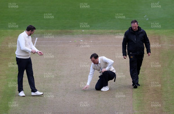 060423 - Glamorgan v Gloucestershire - LV= County Championship - The umpires inspect the pitch after the rain delay