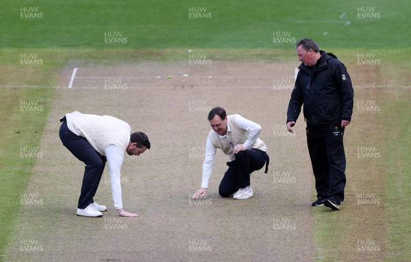 060423 - Glamorgan v Gloucestershire - LV= County Championship - The umpires inspect the pitch after the rain delay