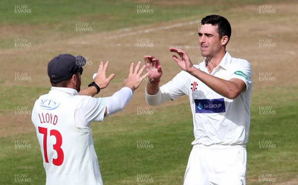 100918 - Glamorgan v Gloucestershire - Specsavers Championship Division Two - Ruaidhri Smith of Glamorgan celebrates with David Lloyd after bowling Miles Hammond out for LBW