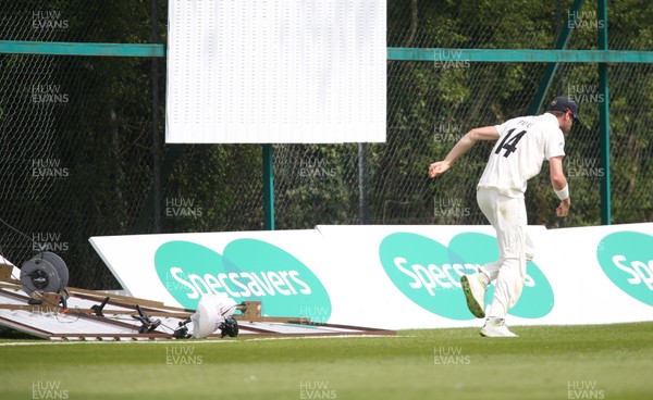 150519 - Glamorgan v Gloucestershire, Specsavers County Championship Division 2, Day 2 - David Payne of Gloucestershire has lucky escape as the sight screen that he was attempting to move collapses towards him
