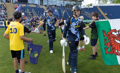 230526 - Glamorgan v Gloucestershire, Vitality Blast Men - Will Smale of Glamorgan and Alex Horton of Glamorgan make their way for the start of the match
