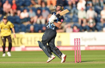 230526 - Glamorgan v Gloucestershire, Vitality Blast Men -  Chris Cooke of Glamorgan  sends the ball towards the boundary but is caught by Craig Miles of Gloucestershire