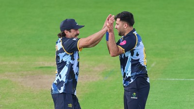 230526 - Glamorgan v Gloucestershire, Vitality Blast Men -  Fazalhaq Farooqi of Glamorgan celebrates with Kiran Carlson of Glamorgan after he takes the wicket of Ollie Price of Gloucestershire