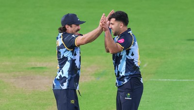 230526 - Glamorgan v Gloucestershire, Vitality Blast Men -  Fazalhaq Farooqi of Glamorgan celebrates with Kiran Carlson of Glamorgan after he takes the wicket of Ollie Price of Gloucestershire