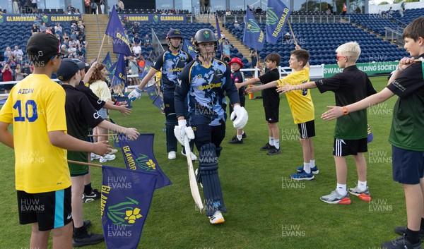 230526 - Glamorgan v Gloucestershire, Vitality Blast Men - Will Smale of Glamorgan and Alex Horton of Glamorgan make their way for the start of the match