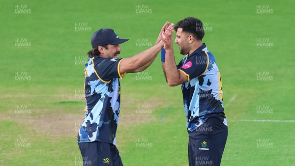 230526 - Glamorgan v Gloucestershire, Vitality Blast Men -  Fazalhaq Farooqi of Glamorgan celebrates with Kiran Carlson of Glamorgan after he takes the wicket of Ollie Price of Gloucestershire