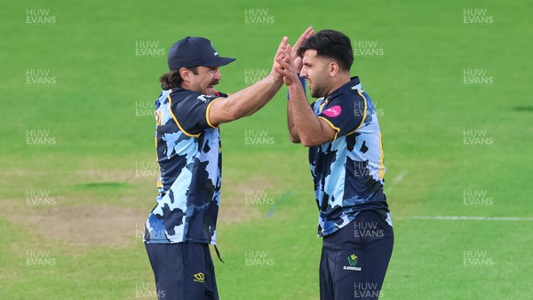 230526 - Glamorgan v Gloucestershire, Vitality Blast Men -  Fazalhaq Farooqi of Glamorgan celebrates with Kiran Carlson of Glamorgan after he takes the wicket of Ollie Price of Gloucestershire