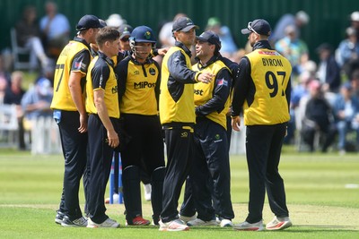 050825 - Glamorgan v Hampshire - Metro Bank One Day Cup - Andy Gorvin of Glamorgan celebrates with team mates after he bowls the ball and Joe Weatherley of Hampshire is LBW
