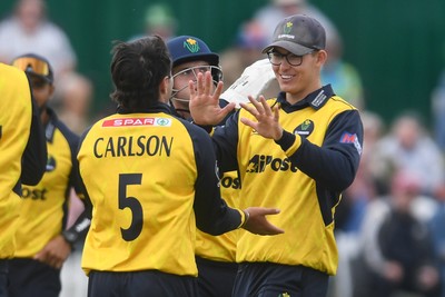 050825 - Glamorgan v Hampshire - Metro Bank One Day Cup - Kiran Carlson of Glamorgan celebrates with team Asa Tribe after he bowls the ball to dismiss Tom Prest of Hampshire