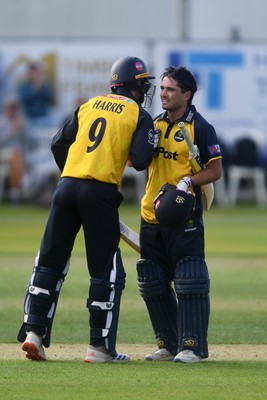 050825 - Glamorgan v Hampshire - Metro Bank One Day Cup - James Harris congratulates Kiran Carlson of Glamorgan as he hits a century