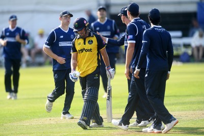 050825 - Glamorgan v Hampshire - Metro Bank One Day Cup - Kiran Carlson of Glamorgan is caught out by Tom Prest of Hampshire but congratulated by Hampshire players for hitting a career best of 135