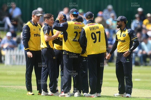 050825 - Glamorgan v Hampshire - Metro Bank One Day Cup - Andy Gorvin of Glamorgan celebrates with team mates after he bowls the ball and Joe Weatherley of Hampshire is LBW