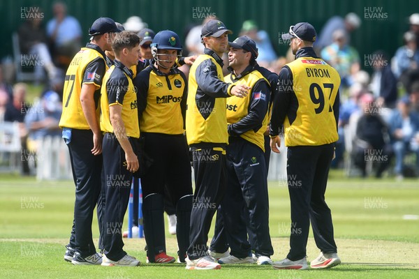 050825 - Glamorgan v Hampshire - Metro Bank One Day Cup - Andy Gorvin of Glamorgan celebrates with team mates after he bowls the ball and Joe Weatherley of Hampshire is LBW
