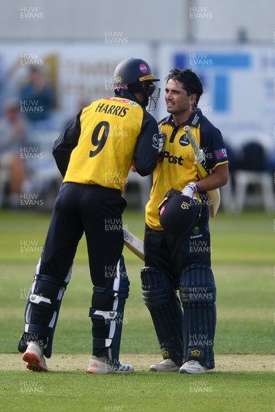 050825 - Glamorgan v Hampshire - Metro Bank One Day Cup - James Harris congratulates Kiran Carlson of Glamorgan as he hits a century
