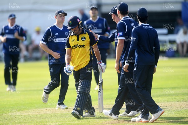 050825 - Glamorgan v Hampshire - Metro Bank One Day Cup - Kiran Carlson of Glamorgan is caught out by Tom Prest of Hampshire but congratulated by Hampshire players for hitting a career best of 135