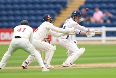 300826 Glamorgan v Hampshire, Rothesay County Championship Division 1 - Tom Prest of Hampshire hits a four over the heads of Chris Cooke of Glamorgan and Colin Ingram of Glamorgan