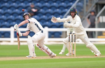 300826 Glamorgan v Hampshire, Rothesay County Championship Division 1 - Ben Brown of Hampshire plays a shot as Chris Cooke of Glamorgan looks on